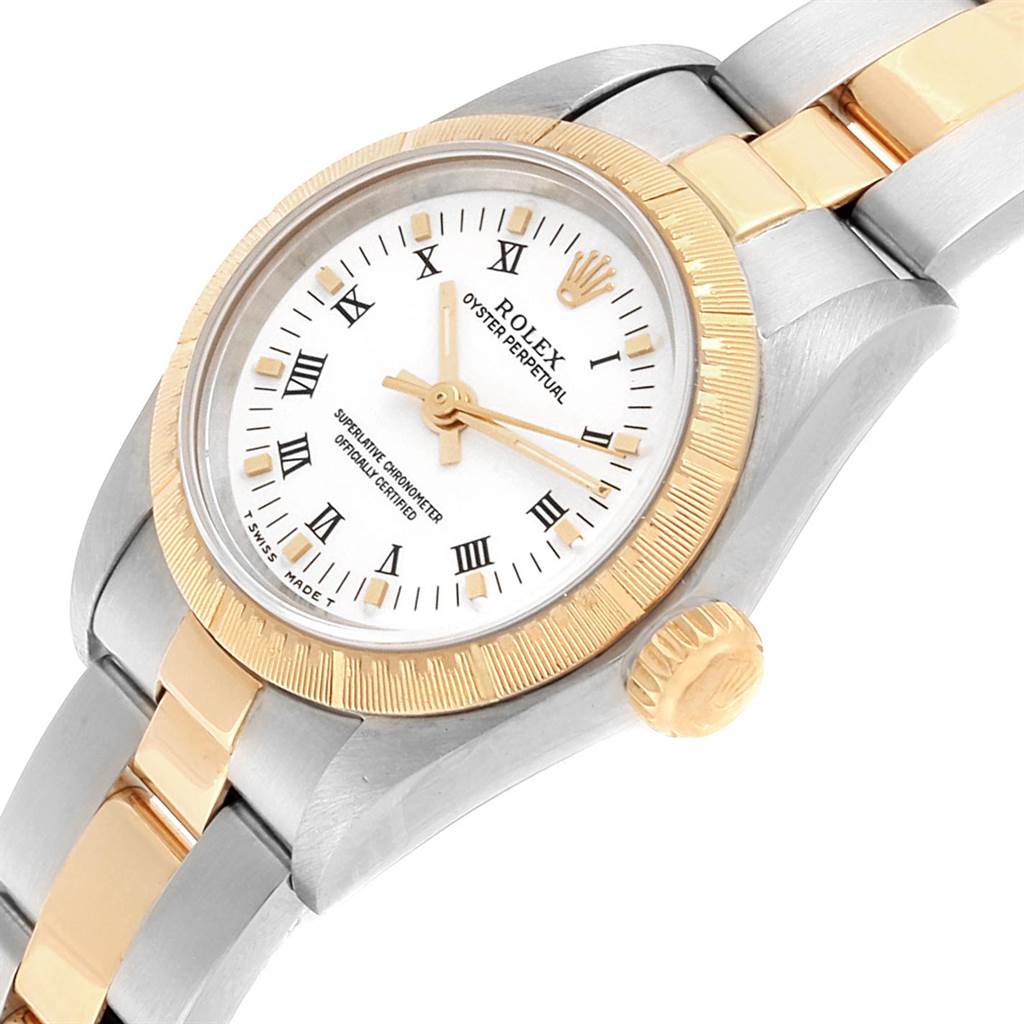 The image shows a close-up angle of a Rolex Oyster Perpetual 67243 Women
s Steel and Gold (two tone) White Dial 67243 Women
s Steel and Gold (two tone) White Dial watch, highlighting the dial, bezel, and part of the bracelet.