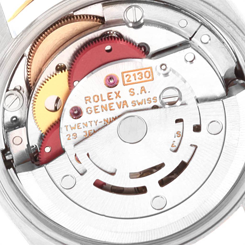 The image shows a close-up of the movement mechanism inside a Rolex Oyster Perpetual 67243 Women
s Steel and Gold (two tone) White Dial 67243 Women
s Steel and Gold (two tone) White Dial watch.