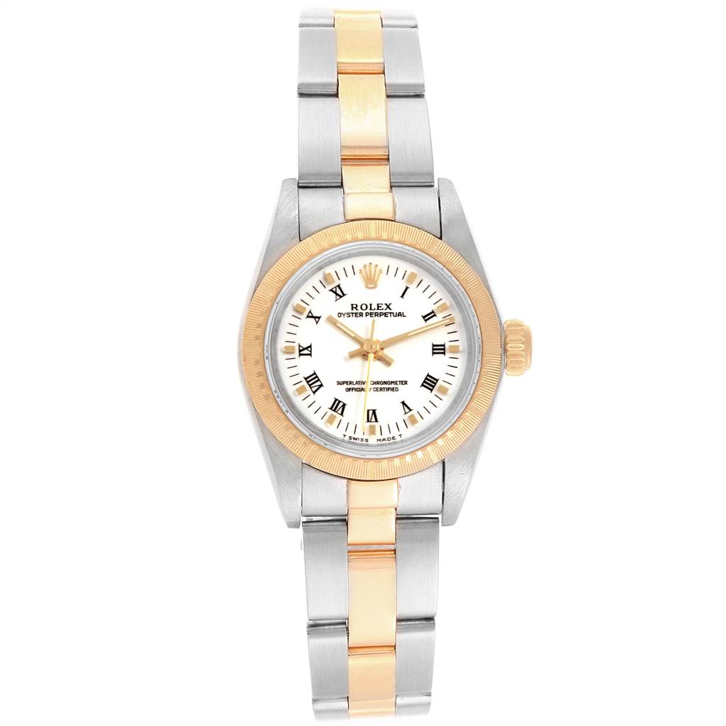 The Oyster Perpetual Rolex watch is shown from a top-down angle, displaying its face, bezel, and bracelet in gold and silver tones.