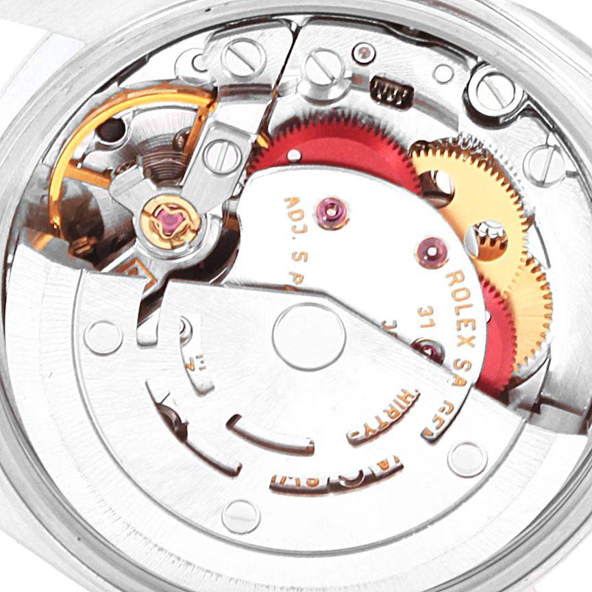 This image shows a close-up view of the movement mechanism of a Rolex Oyster Perpetual 76080 Women
s Stainless Steel Black Dial 76080 Women
s Stainless Steel Black Dial watch.