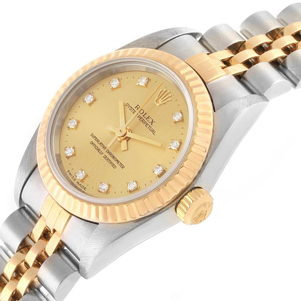 The image shows a close-up angled view of the face, bezel, crown, and part of the bracelet of a Rolex Oyster Perpetual 76193 Women
s Steel and Gold (two tone) Champagne Dial 76193 Women
s Steel and Gold (two tone) Champagne Dial watch.