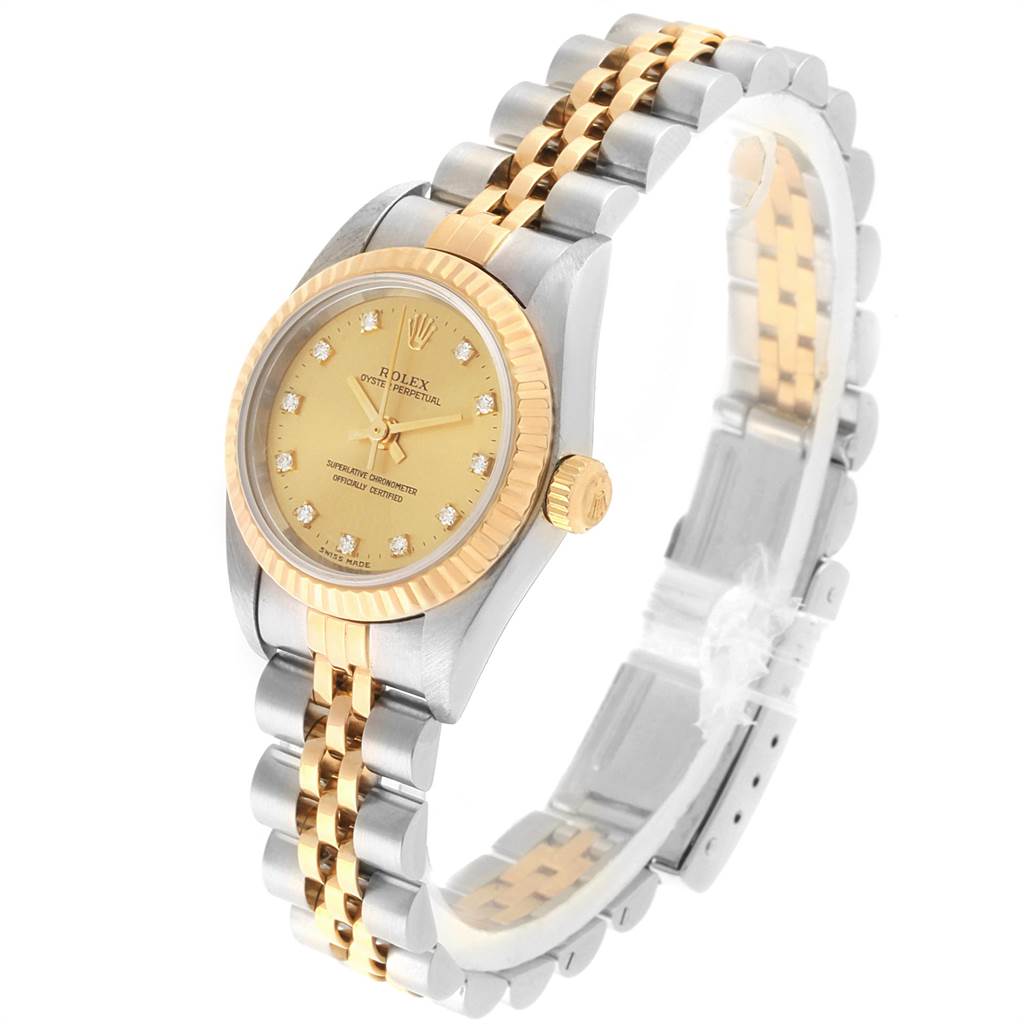 This image shows a Rolex Oyster Perpetual 76193 Women
s Steel and Gold (two tone) Champagne Dial 76193 Women
s Steel and Gold (two tone) Champagne Dial watch at an angle displaying the face, bezel, case, and part of the bracelet.