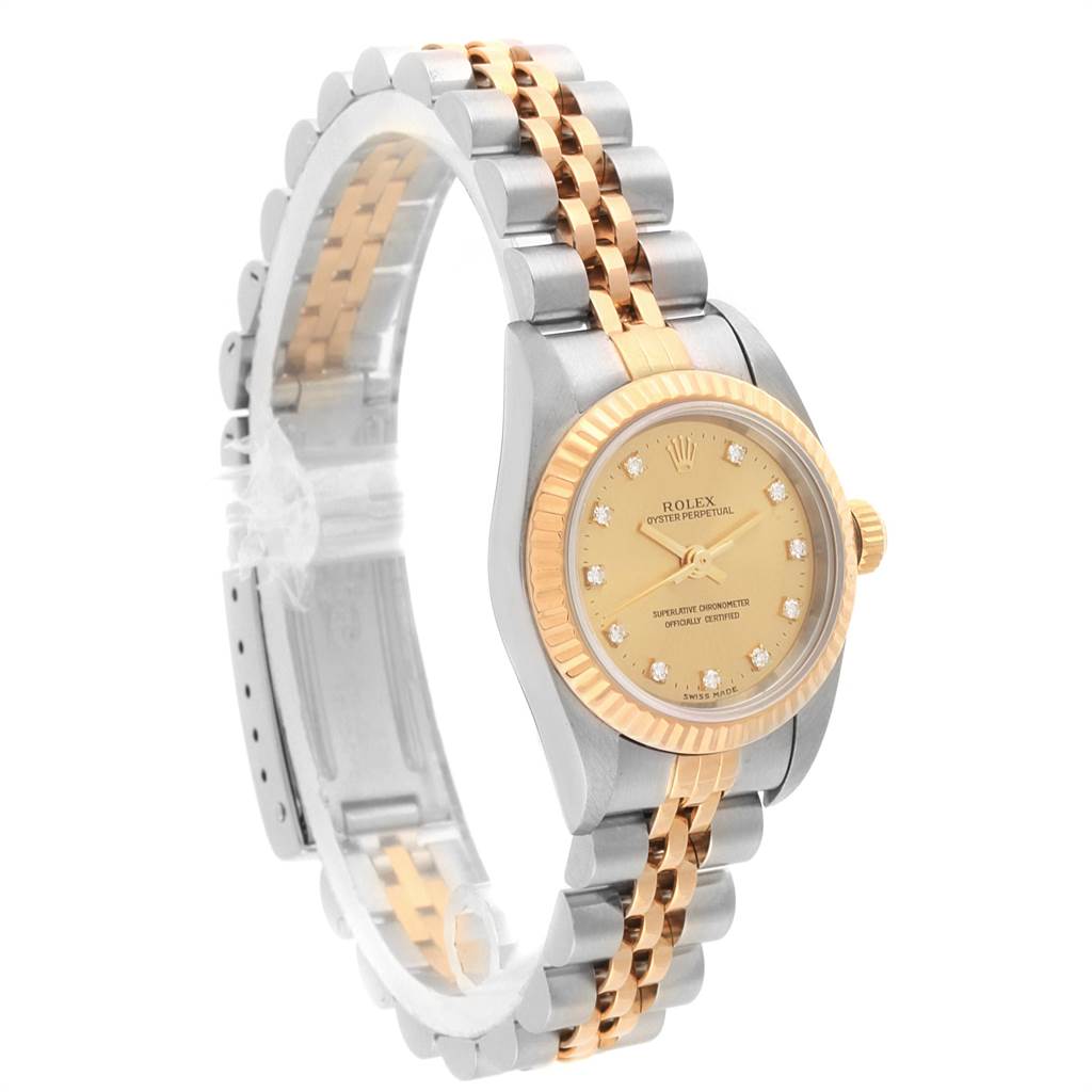 The Rolex Oyster Perpetual 76193 Women
s Steel and Gold (two tone) Champagne Dial 76193 Women
s Steel and Gold (two tone) Champagne Dial watch is shown at an angle displaying the face, bezel, crown, and two-tone bracelet.