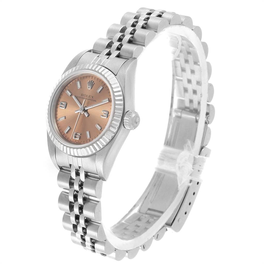 The image showcases a Rolex Oyster Perpetual 76094 Women's Stainless Steel Pink Dial 76094 Women's Stainless Steel Pink Dial watch angled from the front-left, highlighting the face, crown, and bracelet.