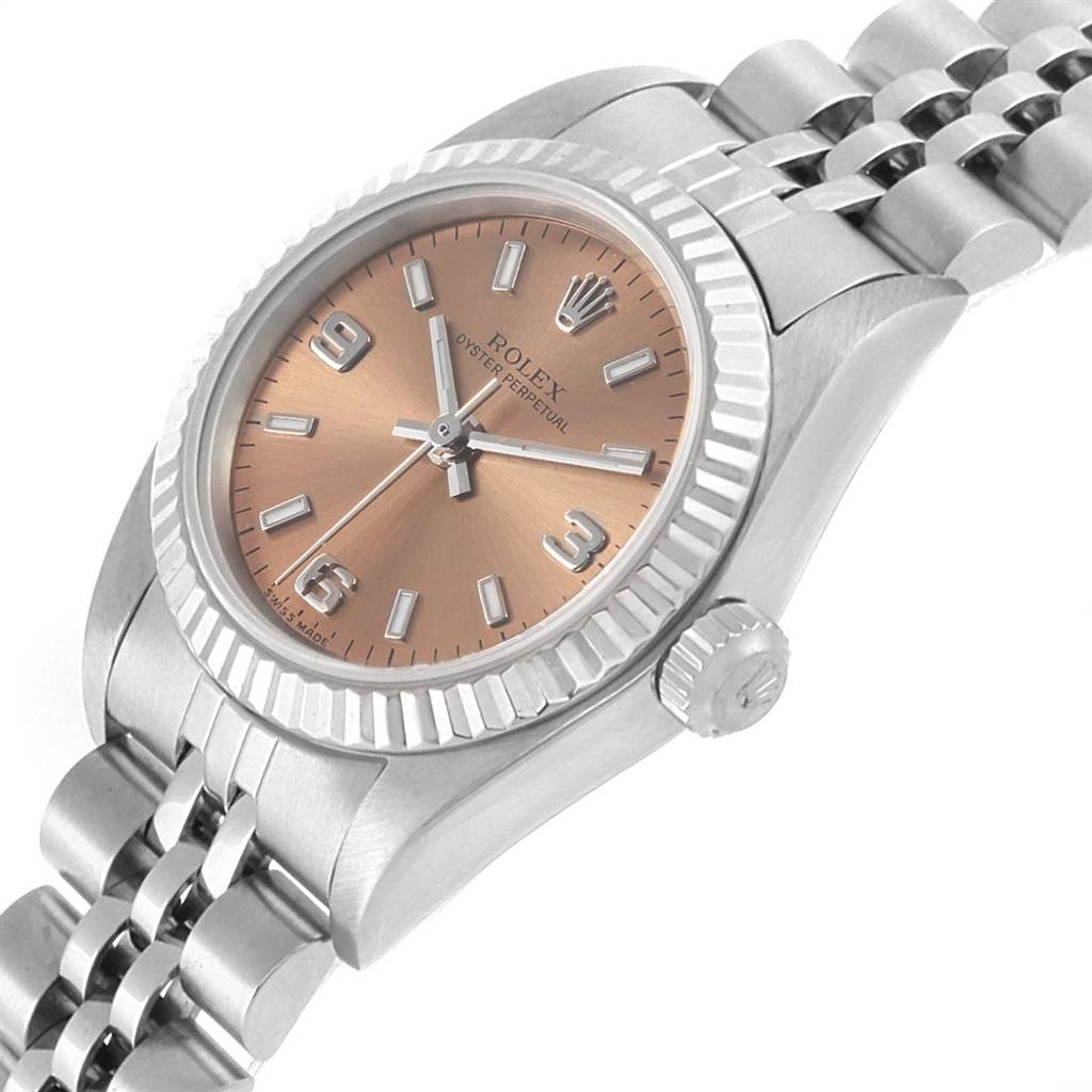 This image shows a close-up angle of a Rolex Oyster Perpetual 76094 Women's Stainless Steel Pink Dial 76094 Women's Stainless Steel Pink Dial watch, focusing on the dial, bezel, crown, and part of the bracelet.