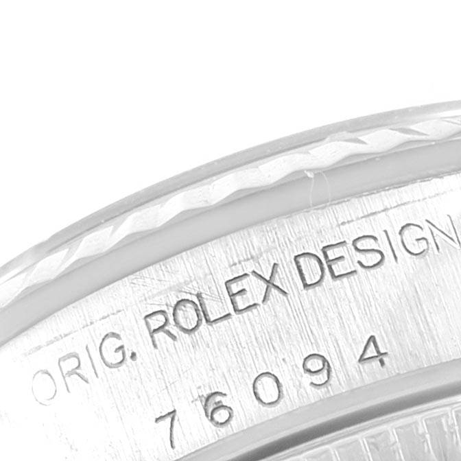 This image shows a close-up of the Rolex Oyster Perpetual 76094 Women's Stainless Steel Pink Dial 76094 Women's Stainless Steel Pink Dial model's case side with engraved text "ORIG. ROLEX DESIGN 76094."