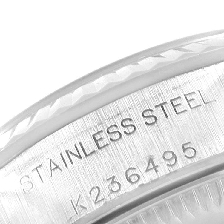 This image shows a close-up of the stainless steel and serial number on the casing of a Rolex Oyster Perpetual 76094 Women's Stainless Steel Pink Dial 76094 Women's Stainless Steel Pink Dial watch.