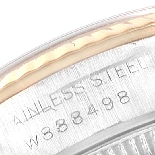 This image shows a close-up of the casing edge and engraved serial number on an Oyster Perpetual Rolex watch.