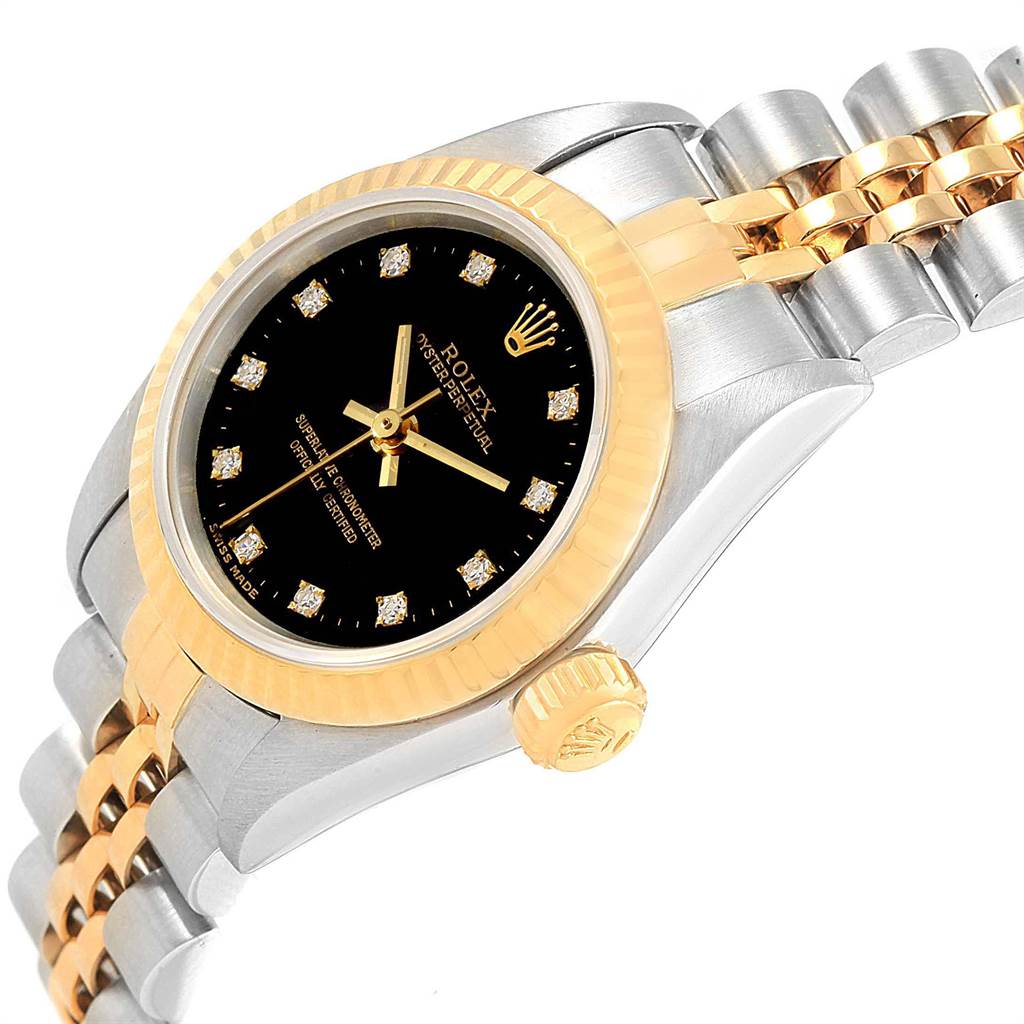 This image shows a side view of a Rolex Oyster Perpetual 67193 Women
s Steel and Gold (two tone) Black Dial 67193 Women
s Steel and Gold (two tone) Black Dial watch displaying its gold bezel, crown, and a segment of the band.