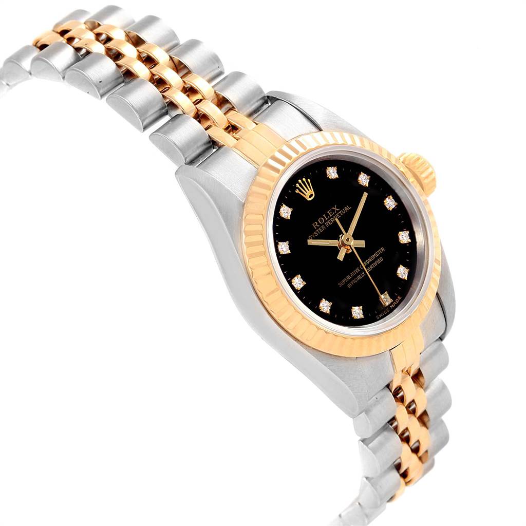 The image shows a Rolex Oyster Perpetual 67193 Women
s Steel and Gold (two tone) Black Dial 67193 Women
s Steel and Gold (two tone) Black Dial watch at a slight angle, highlighting its black dial, diamond hour markers, and two-tone bracelet.