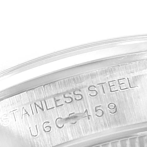 This image shows a close-up of the case back of a Rolex Oyster Perpetual 67180 Women
s Stainless Steel Black Dial 67180 Women
s Stainless Steel Black Dial watch, highlighting its stainless steel material and serial number.
