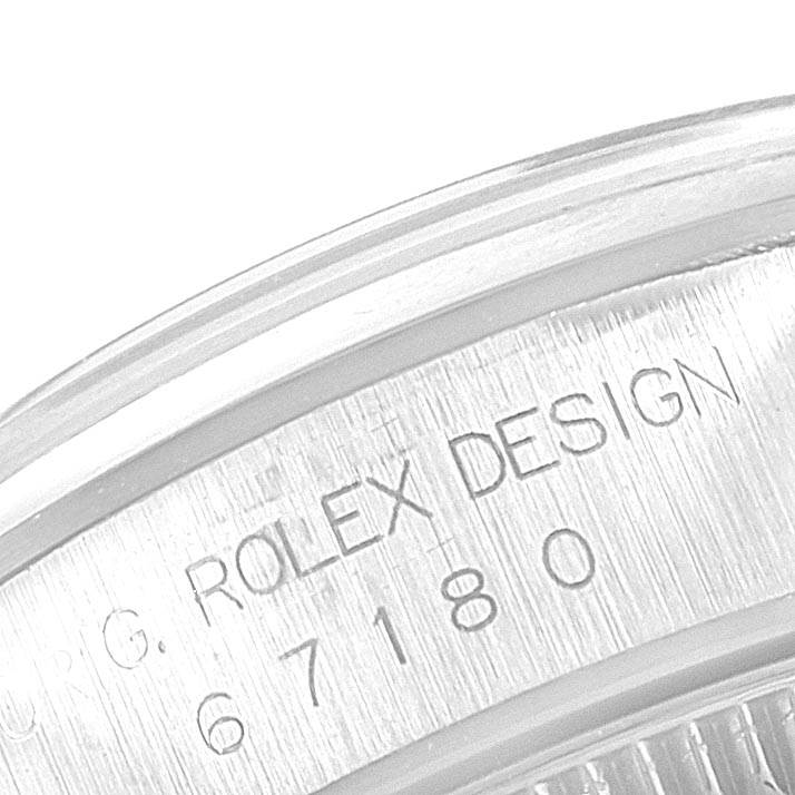 The image shows a close-up of the engraved text on the case back rim of the Rolex Oyster Perpetual 67180 Women
s Stainless Steel Black Dial 67180 Women
s Stainless Steel Black Dial watch.
