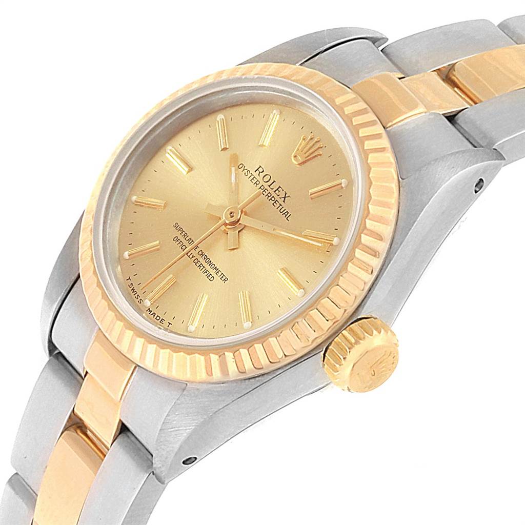 The image shows a Rolex Oyster Perpetual 67193 Women's Steel and Gold (two tone) Champagne Dial 67193 Women's Steel and Gold (two tone) Champagne Dial watch at an angled view, highlighting the gold bezel, dial, and crown along with its two-tone bracelet.