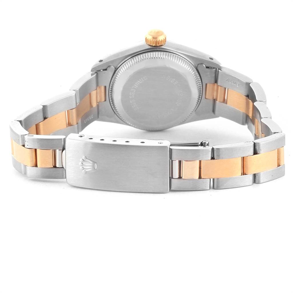 The image shows the back angle of a Rolex Oyster Perpetual 67193 Women's Steel and Gold (two tone) Champagne Dial 67193 Women's Steel and Gold (two tone) Champagne Dial watch, highlighting its case back and two-tone bracelet with clasp.