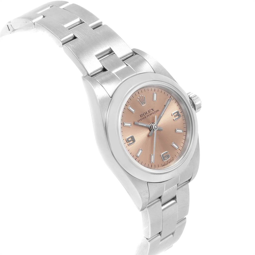 The Rolex Oyster Perpetual 76080 Women's Stainless Steel Pink Dial 76080 Women's Stainless Steel Pink Dial watch is shown from a slight angle, displaying its bracelet, case, crown, and dial with hour markers.