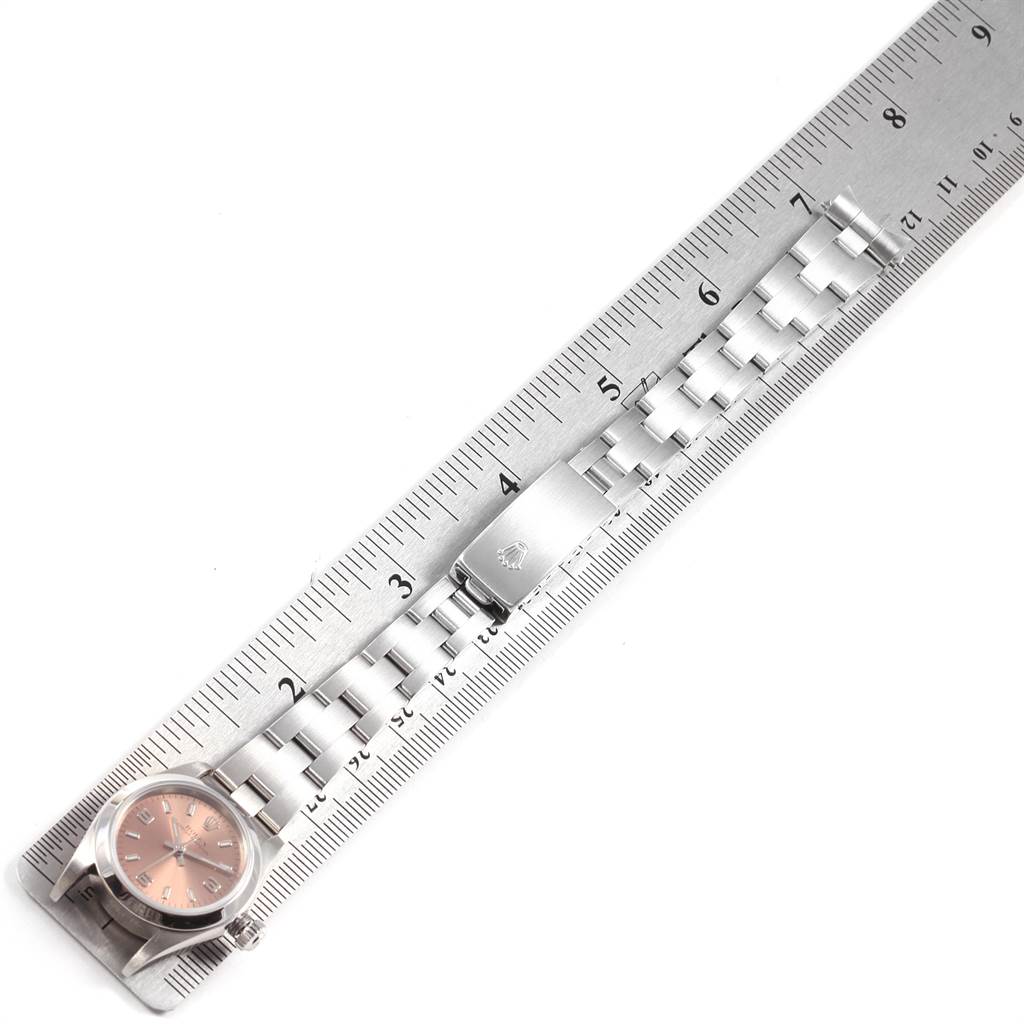 The image shows a Rolex Oyster Perpetual 76080 Women's Stainless Steel Pink Dial 76080 Women's Stainless Steel Pink Dial watch with a metal strap and clasp, measured against a ruler.