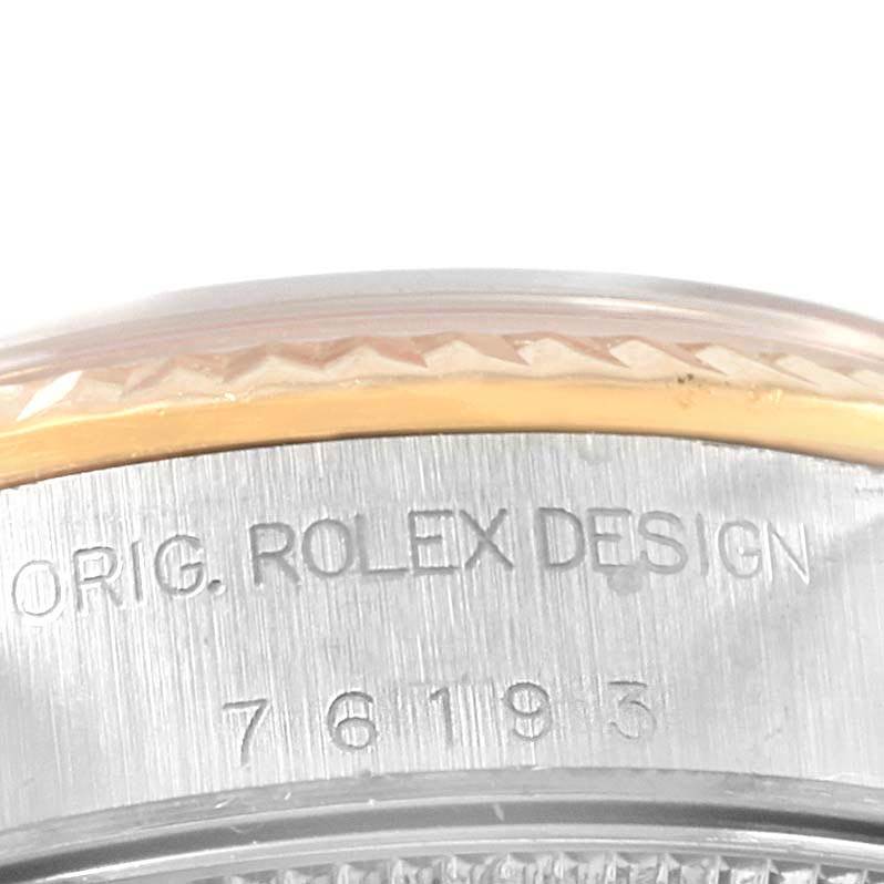 The image shows a close-up of the side of a Rolex Oyster Perpetual 76193 Women's Steel and Gold (two tone) Champagne Dial 76193 Women's Steel and Gold (two tone) Champagne Dial watch, highlighting its serial engraving.