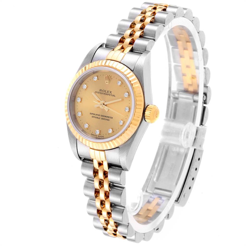The image shows a Rolex Oyster Perpetual 76193 Women's Steel and Gold (two tone) Champagne Dial 76193 Women's Steel and Gold (two tone) Champagne Dial watch from a front-left angle, highlighting the face, bezel, and part of the bracelet.