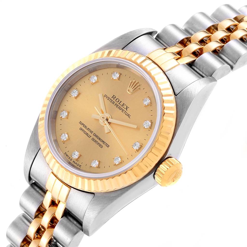 This image shows a Rolex Oyster Perpetual 76193 Women's Steel and Gold (two tone) Champagne Dial 76193 Women's Steel and Gold (two tone) Champagne Dial watch from an angled view, highlighting the bezel, dial, crown, and bracelet.