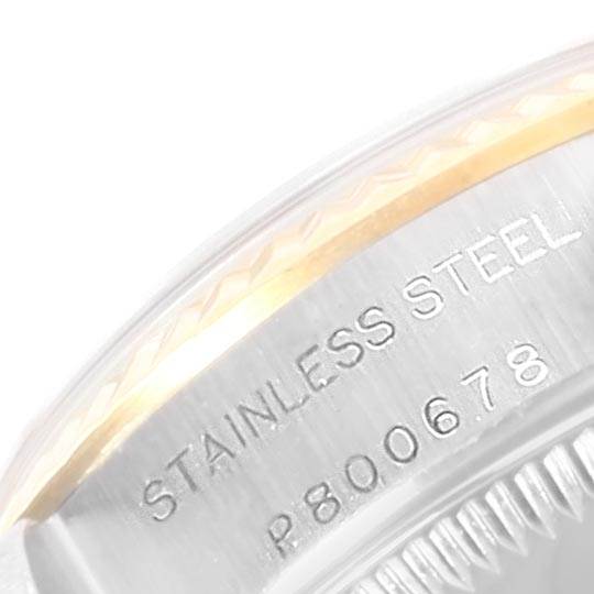 This image shows a close-up of the side of a Rolex Oyster Perpetual 76193 Women's Steel and Gold (two tone) Champagne Dial 76193 Women's Steel and Gold (two tone) Champagne Dial watch, highlighting the "STAINLESS STEEL" engraving.