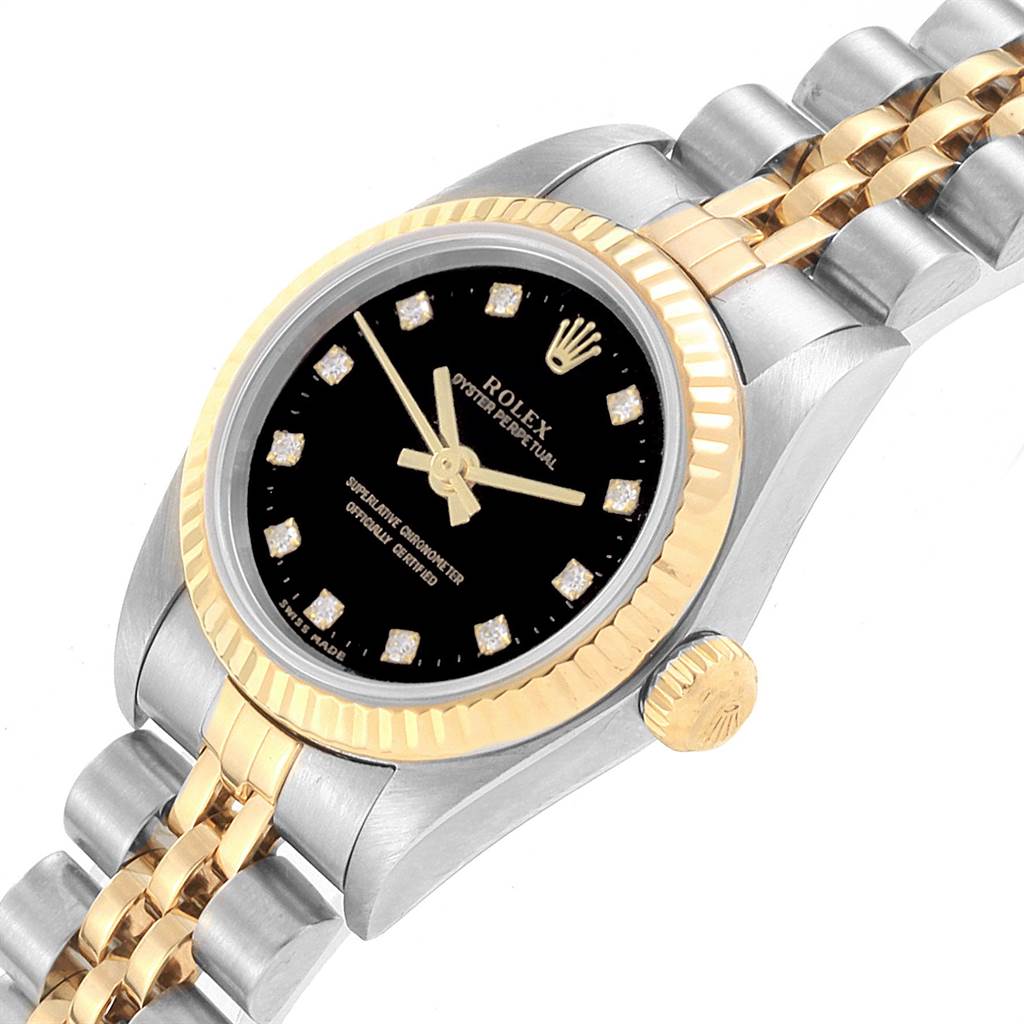 The image shows a close-up of the face and part of the band of a Rolex Oyster Perpetual 76193 Women
s Steel and Gold (two tone) Black Dial 76193 Women
s Steel and Gold (two tone) Black Dial watch.