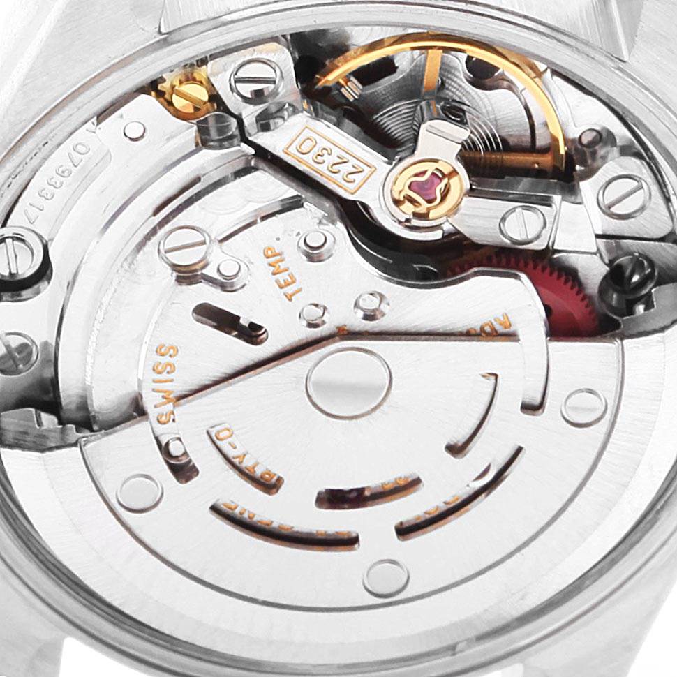 This image shows a close-up of the Rolex Oyster Perpetual 76193 Women
s Steel and Gold (two tone) Black Dial 76193 Women
s Steel and Gold (two tone) Black Dial model
s movement from the back, revealing its intricate mechanical parts.
