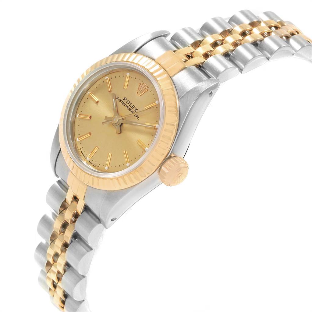 This image shows the side and partial top view of the Rolex Oyster Perpetual 67193 Women's Steel and Gold (two tone) Champagne Dial 67193 Women's Steel and Gold (two tone) Champagne Dial watch, highlighting the gold bezel, crown, and two-tone bracelet.