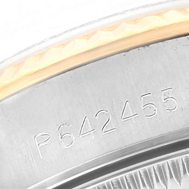 The close-up angle shows the serial number etched on the side of the Rolex Oyster Perpetual 67193 Women's Steel and Gold (two tone) Champagne Dial 67193 Women's Steel and Gold (two tone) Champagne Dial watch case.