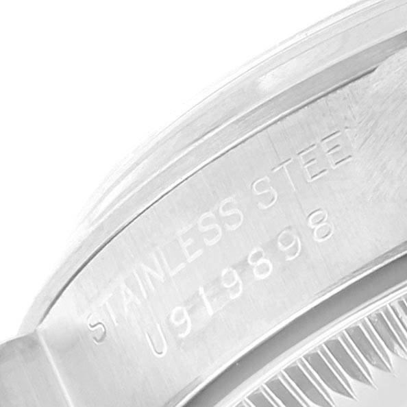 The image shows a close-up of the engraved stainless steel part of a Rolex Oyster Perpetual 67180 Women's Stainless Steel Pink Dial 67180 Women's Stainless Steel Pink Dial watch.
