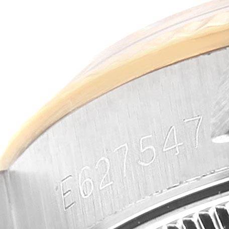 This close-up image shows the serial number engraved on the side of the case of a Rolex Oyster Perpetual 67193 Women's Steel and Gold (two tone) White Dial 67193 Women's Steel and Gold (two tone) White Dial watch.