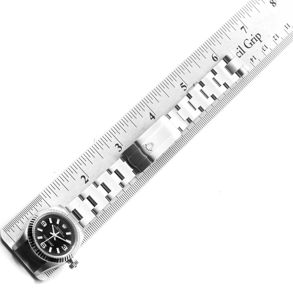 The image shows the Rolex Oyster Perpetual 176234 Women
s Stainless Steel Black Dial 176234 Women
s Stainless Steel Black Dial watch from an overhead angle, highlighting the dial, bracelet, and part of a ruler for scale.