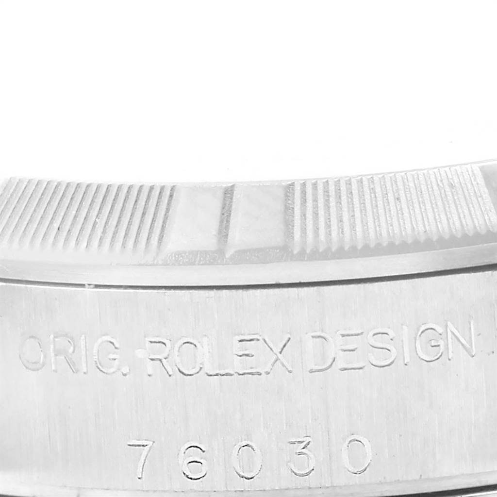 This image shows a close-up of the side of an Oyster Perpetual Rolex watch, featuring the engravings "ORIG. ROLEX DESIGN" and the model number "76030."