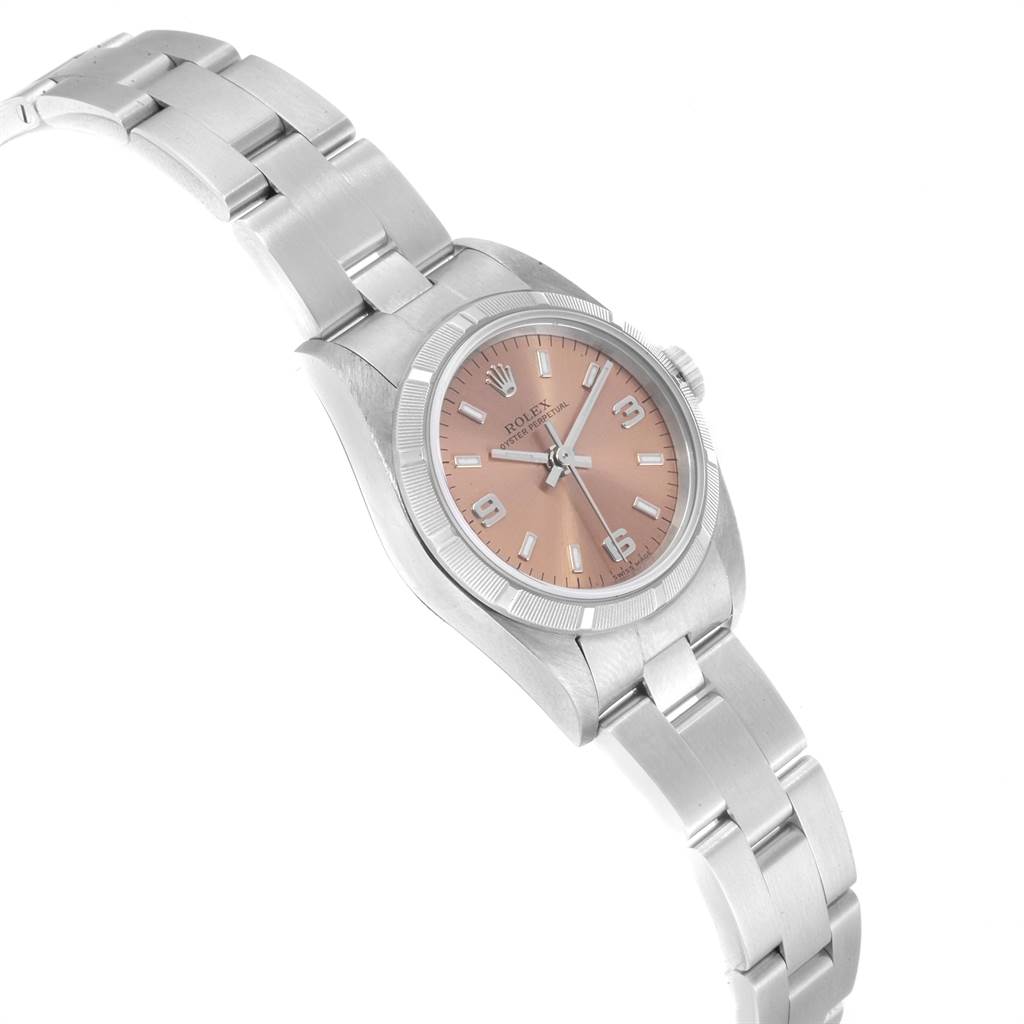 The image shows a Rolex Oyster Perpetual 76030 Women's Stainless Steel Pink Dial 76030 Women's Stainless Steel Pink Dial watch at a tilted angle, highlighting its face, bezel, and metal bracelet.