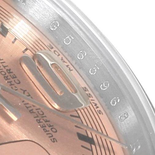This close-up image of a Rolex Oyster Perpetual 176200 Women's Stainless Steel Pink Dial 176200 Women's Stainless Steel Pink Dial watch shows part of the dial and a portion of the chapter ring with numbers.