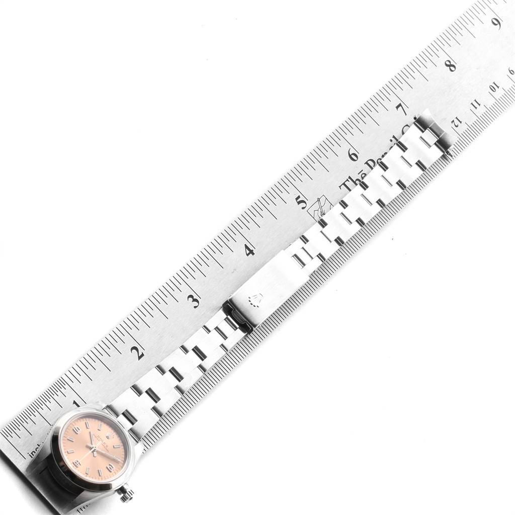 The image shows a Rolex Oyster Perpetual 76080 Women's Stainless Steel Pink Dial 76080 Women's Stainless Steel Pink Dial watch laid flat next to a ruler, displaying the dial and bracelet.