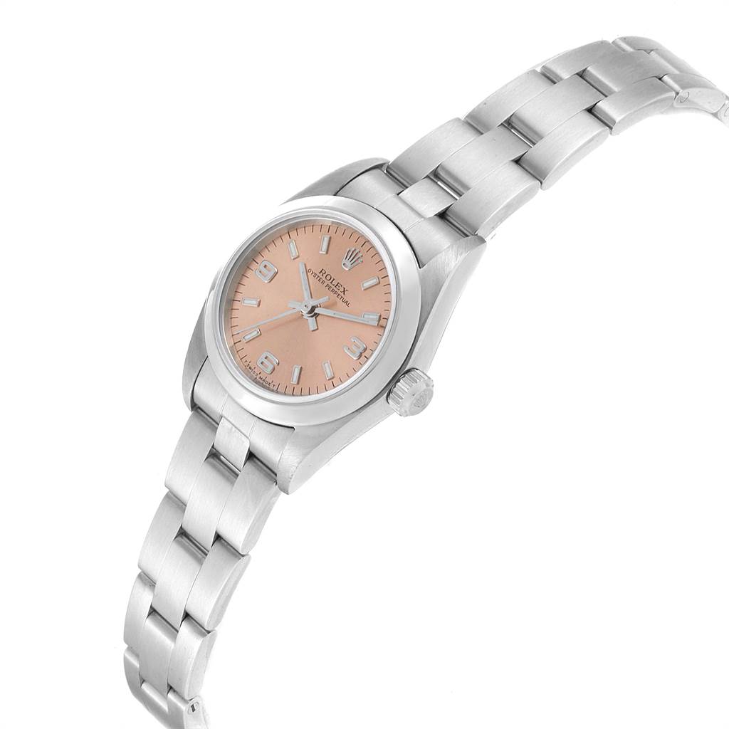 The Rolex Oyster Perpetual 76080 Women's Stainless Steel Pink Dial 76080 Women's Stainless Steel Pink Dial watch is shown at an angle that highlights the face, bezel, crown, and bracelet.