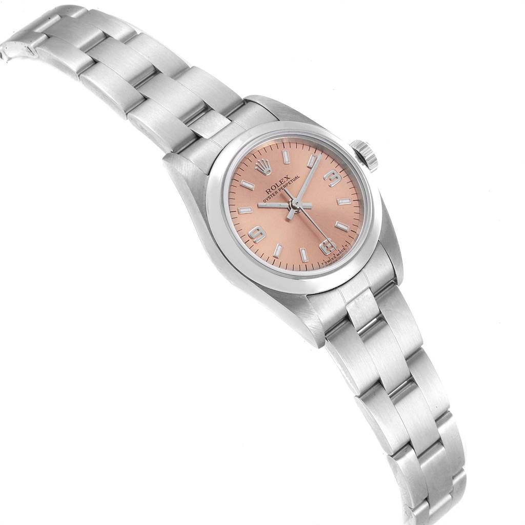 The image shows a Rolex Oyster Perpetual 76080 Women's Stainless Steel Pink Dial 76080 Women's Stainless Steel Pink Dial watch viewed from a slight front angle, highlighting its pink dial and metal bracelet.