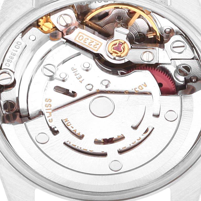 The image shows a close-up view of the movement and inner workings of a Rolex Oyster Perpetual 76080 Women's Stainless Steel Pink Dial 76080 Women's Stainless Steel Pink Dial watch.
