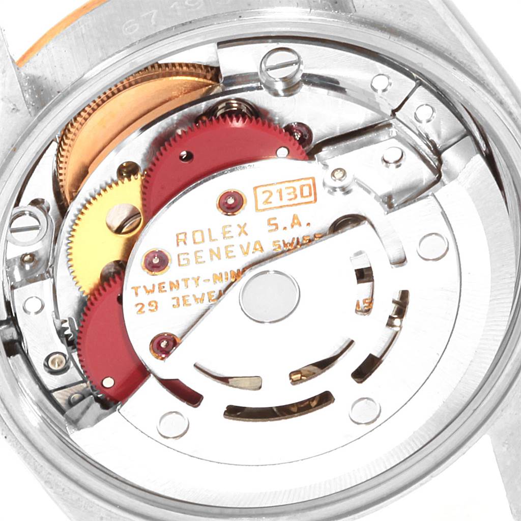 The image shows a close-up view of the movement of a Rolex Oyster Perpetual 67193 Women's Steel and Gold (two tone) Champagne Dial 67193 Women's Steel and Gold (two tone) Champagne Dial model, highlighting its gears and internal mechanisms.