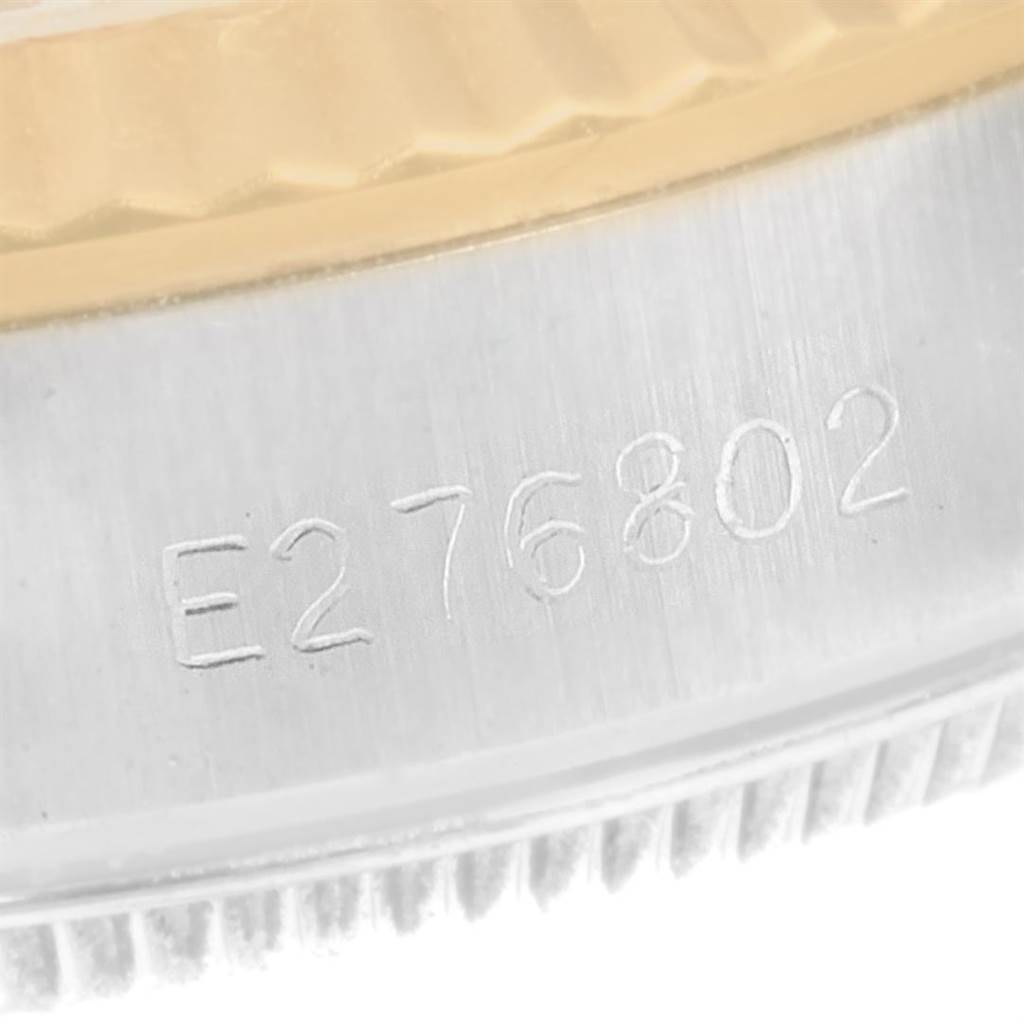 This image shows a close-up of the case side, bezel, and the serial number engraving on a Rolex Oyster Perpetual 67193 Women's Steel and Gold (two tone) Champagne Dial 67193 Women's Steel and Gold (two tone) Champagne Dial watch.
