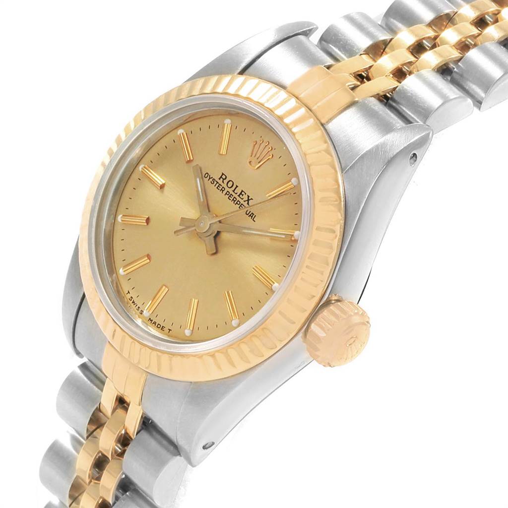 This image shows a Rolex Oyster Perpetual 67193 Women's Steel and Gold (two tone) Champagne Dial 67193 Women's Steel and Gold (two tone) Champagne Dial watch from an angled side view highlighting the gold dial, bezel, and two-tone bracelet.