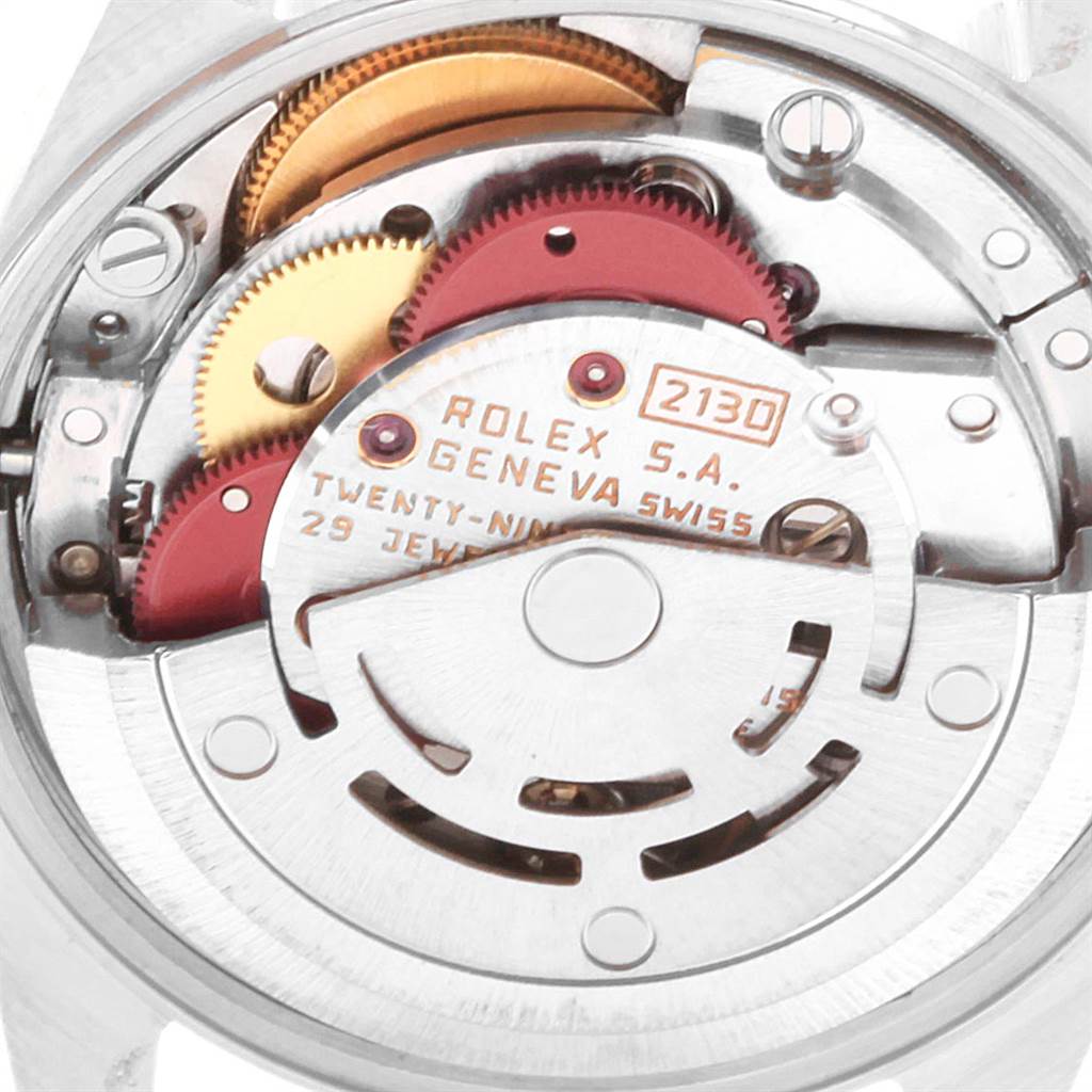 The image shows the inner mechanical components of a Rolex Oyster Perpetual 67193 Women's Steel and Gold (two tone) Champagne Dial 67193 Women's Steel and Gold (two tone) Champagne Dial watch, including gears and markings.