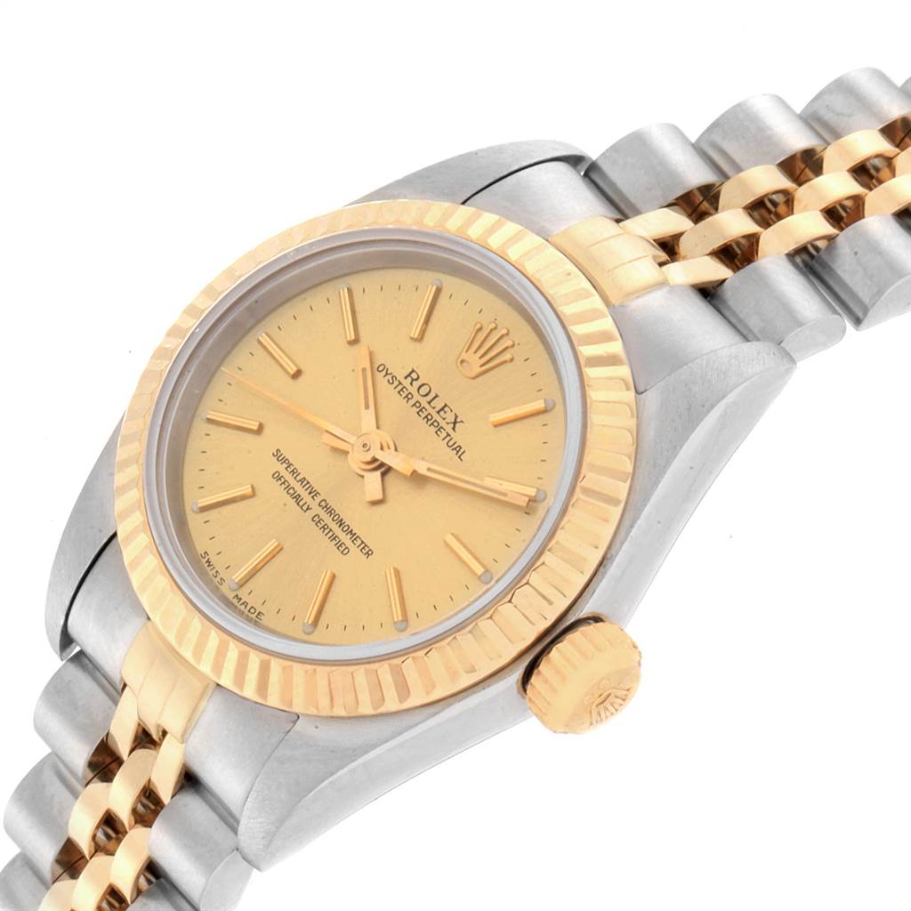 This image shows a close-up angle of a Rolex Oyster Perpetual 76193 Women's Steel and Gold (two tone) Champagne Dial 76193 Women's Steel and Gold (two tone) Champagne Dial watch highlighting the dial, bezel, crown, and part of the bracelet.