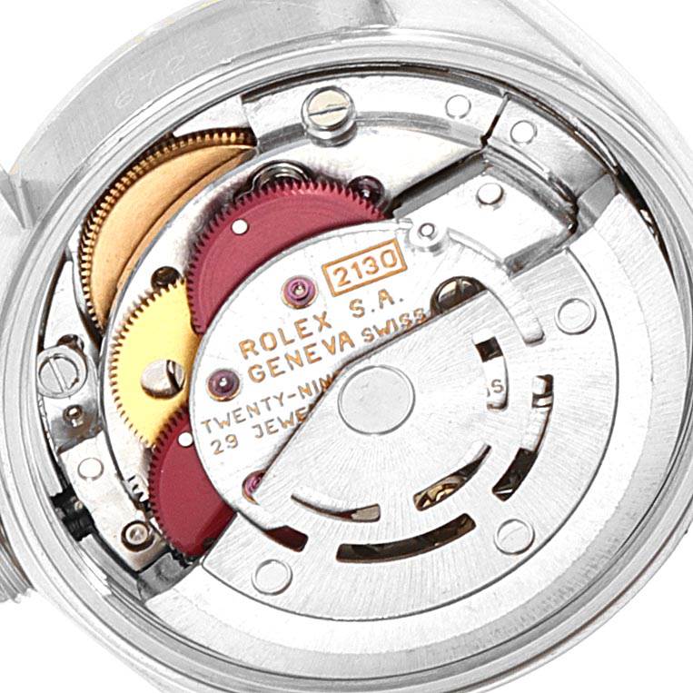 This image shows the internal movement mechanism of the Rolex Oyster Perpetual 67233 Women's Steel and Gold (two tone) White Dial 67233 Women's Steel and Gold (two tone) White Dial watch, featuring gears and the rotor.
