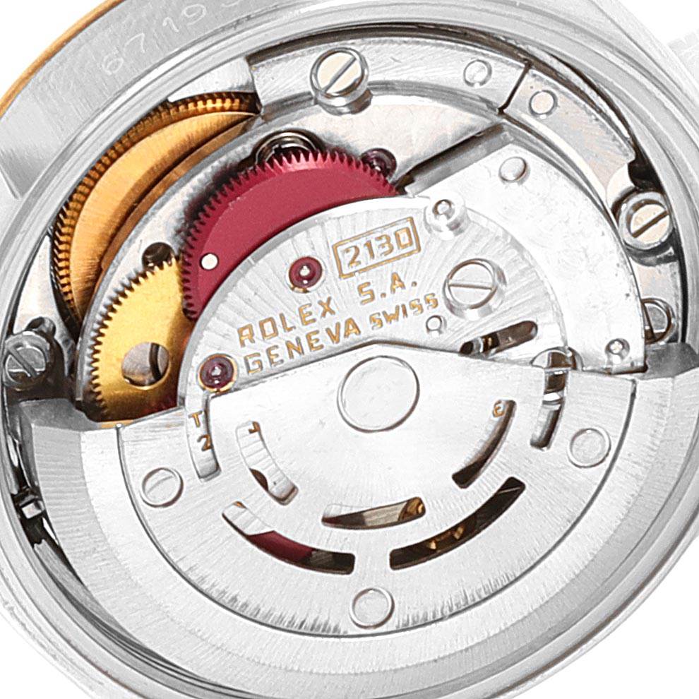 This is a close-up view of the movement mechanism in a Rolex Oyster Perpetual 67193 Women's Steel and Gold (two tone) White Dial 67193 Women's Steel and Gold (two tone) White Dial watch, specifically showing gears and the rotor.