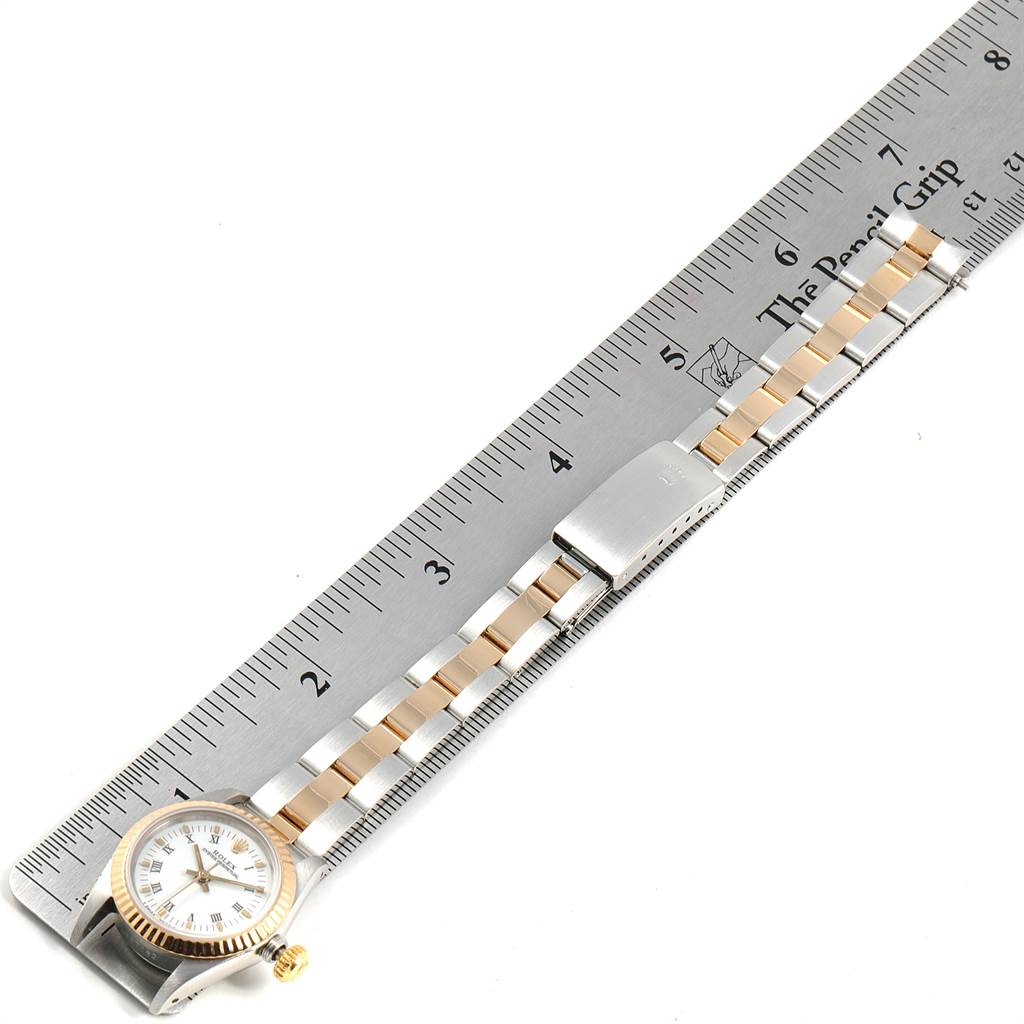The Rolex Oyster Perpetual 67193 Women's Steel and Gold (two tone) White Dial 67193 Women's Steel and Gold (two tone) White Dial watch is shown from a top-down angle, placed next to a ruler indicating its length.