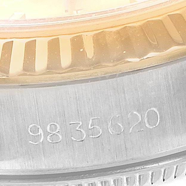 This close-up image shows the serial number on the case and part of the bezel of a Rolex Oyster Perpetual 67193 Women's Steel and Gold (two tone) Champagne Dial 67193 Women's Steel and Gold (two tone) Champagne Dial watch.