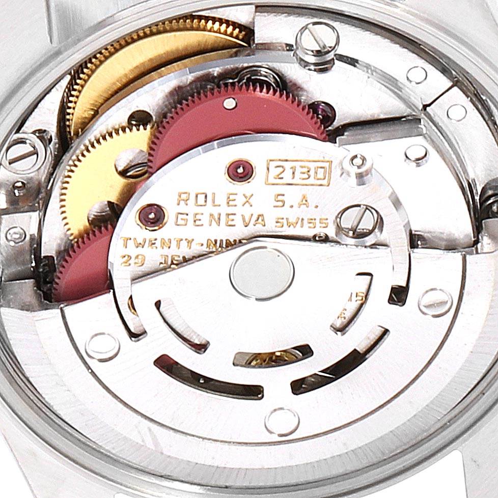 This image shows the intricate internal movement of a Rolex Oyster Perpetual 67193 Women's Steel and Gold (two tone) Champagne Dial 67193 Women's Steel and Gold (two tone) Champagne Dial watch, specifically the caliber 2130.