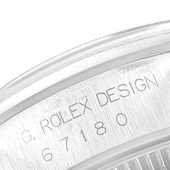 A close-up view of the engraving on the case of a Rolex Oyster Perpetual 67180 Women's Stainless Steel Pink Dial 67180 Women's Stainless Steel Pink Dial watch is shown.