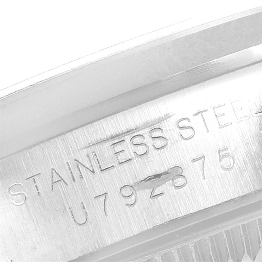 This image shows a close-up of the case back engraving on a Rolex Oyster Perpetual 67180 Women's Stainless Steel Pink Dial 67180 Women's Stainless Steel Pink Dial watch, highlighting the "Stainless Steel" text and part of the serial number.